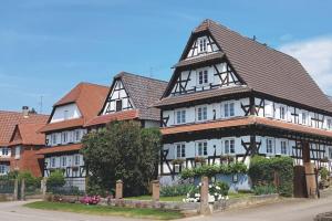 a large building with a tiled roof at Au petit nid de Seebach in Seebach