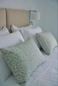 a bed with two pillows on top of it at Casa Adelaide in Capri
