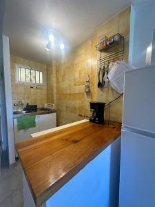 a kitchen with a wooden counter top and a refrigerator at Jupiter in Benalmádena
