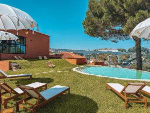 a resort with a swimming pool and lounge chairs at The Lost Garden in Vila Nova de Gaia