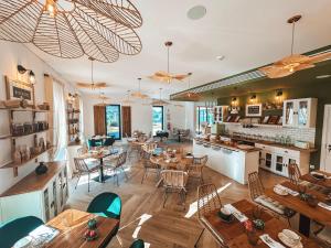 a restaurant with tables and chairs and a kitchen at The Lost Garden in Vila Nova de Gaia