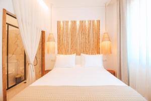 a bedroom with a large white bed with white pillows at The Lost Garden in Vila Nova de Gaia +56 photos