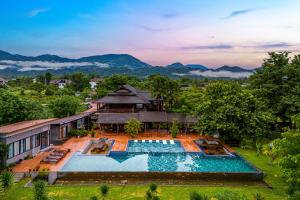 an aerial view of a resort with a swimming pool at Lisha Garden Resort Hotel in Vang Vieng