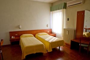 Postel nebo postele na pokoji v ubytování Hotel Europa