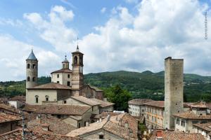 a view of a town with two towers and roofs at Residenza Antica Canonica in Città di Castello