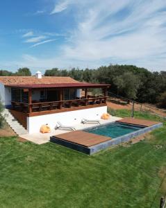 a villa with a swimming pool and a house at Courela do Monte Novo II in Santa Susana