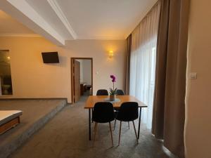 a room with a table and chairs and a window at Alatoni Beach Hotel in Sozopol +32 photos