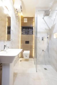 a white bathroom with a sink and a shower at House 241 in Abuja +95 photos