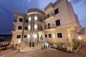 a large white building with lights on at House 241 in Abuja