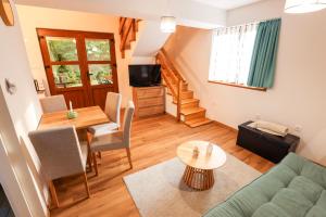 a living room with a couch and a table at Luxury Love Cottage Spa- privatni jacuzzi &sauna , mir i privatnost in Velika Gorica