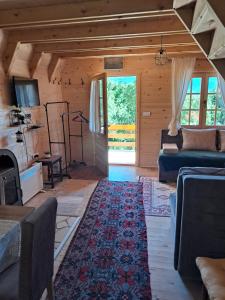 a living room with a couch and a rug at Etno house Bajka in Žabljak