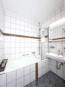 a bathroom with a tub and a sink at Ferienwohnung Hexenstieg in Sankt Andreasberg