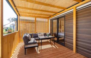 a patio with a couch and a table on a deck at Batana Mobile Home in Banjole +6 photos