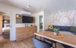 a living room with a couch and a dining table at Batana Mobile Home in Banjole