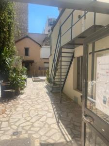 einen Gang neben einem Gebäude mit einer Treppe in der Unterkunft Eiffel Tour Cosy Jade in Paris