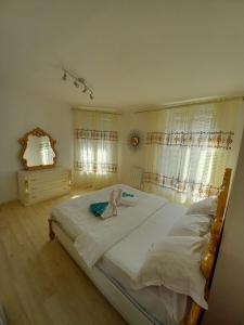 a large white bed in a bedroom with a window at Les jardins secrets in Romilly-sur-Seine
