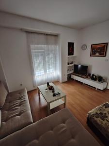 a living room with a couch and a coffee table at Happy house in Kruševac