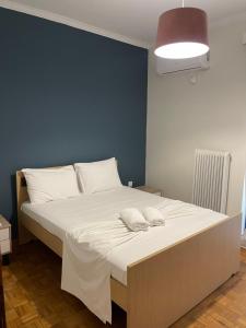 a bed with two white towels on it in a room at Almeta Apartment 2 in Chios