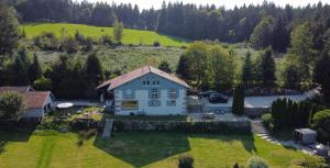 an aerial view of a house in a field at Villa d'exception LA BELLE DES VOSGES 4 étoiles, bain nordique, sauna, billard etc in Le Tholy