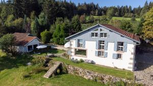 an aerial view of a white house with a stone wall at Villa d'exception LA BELLE DES VOSGES 4 étoiles, bain nordique, sauna, billard etc in Le Tholy