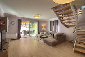 a living room with a couch and a staircase at Ferienhaus mit Privatpool für 8 Personen ca 120 qm in Mugeba, Istrien Istrische Riviera in Mugeba