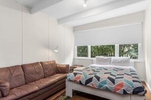 a living room with a couch and a bed at Skenes Creek Beach Retreat Free Wi-Fi Ocean views. in Skenes Creek