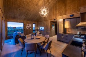 a kitchen and living room with a table and chairs at Skistadion Hafjell in Hafjell