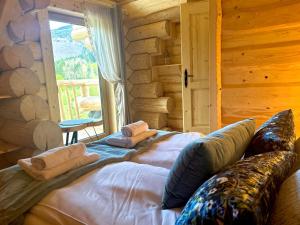 a bedroom with two beds in a log cabin at Bale na Skale Chata & SPA-Zawoja in Skawica