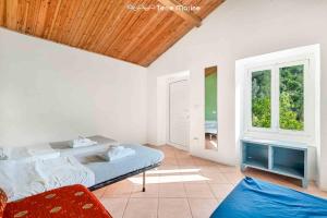 a bedroom with a bed and two windows at Blu Isola, Terre Marine in Corniglia