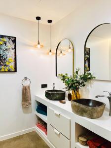 a bathroom with two sinks and two mirrors at Garden House, Playa Honda in Arrecife
