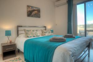 Rúm í herbergi á SeaHorse Penthouse