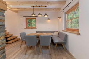 a dining room with a table and chairs at Luxury Villa TINKA in Zgornje Gorje