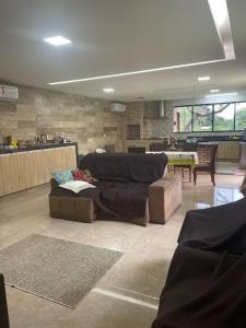 a living room with a couch and a table at Chácara Recanto Monjolinho in Planaltina