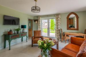 a living room with a couch and a table at Self-contained cosy one bedroom holiday barn in Cowbridge