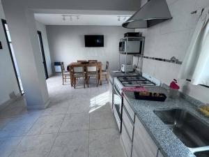 a kitchen with a stove and a table in it at Casa Pepe & Loli in La Cieneguita
