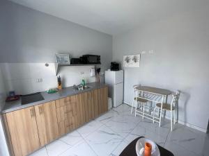 a small kitchen with a sink and a refrigerator at Viva Alto Vista! in Noord