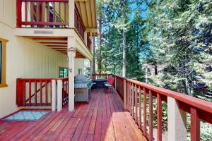 a porch of a house with a wooden deck at Windwood Inn in Shaver Lake