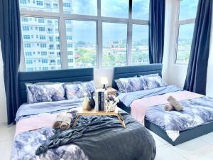 two beds in a room with a large window at SD 1-10Pax Puchong Sky Pod Residence IOI Mall WiFi in Puchong +13 photos