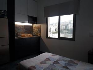 a bedroom with a bed and a window at Inviting 1-Bed Apartment in Dbayeh in Dbayeh +5 photos