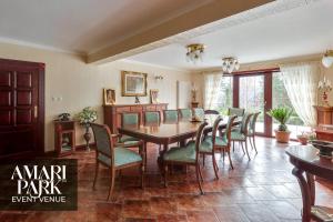 a dining room with a table and chairs at AMARI PARK Residence in Golyama Zhelyazna