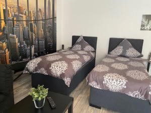 a bedroom with a bed and a table and a city at Appartement Manhattan in Blieskastel +3 photos