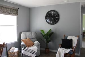 a room with a chair and a clock on the wall at Stony Lane Retreat in Clare