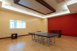 ドバイにあるStunning View 1 Bedroom Apartment Pool & Gymの赤い壁の部屋の卓球台