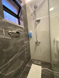 a bathroom with a shower and a toilet at Chic Apartments For Rent ave0-6 in Amman