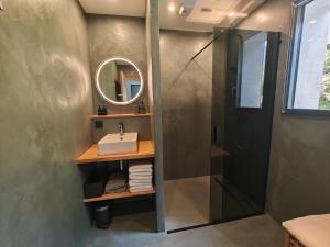 a bathroom with a shower and a sink and a mirror at La Fruitière de Vérel, logements modulables neufs, calmes, entre lac et montagne, max 11 personnes in Rovagny +26 photos