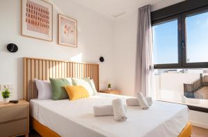 a bedroom with a large bed with a large window at Myflats Campello Beach in El Campello +109 photos