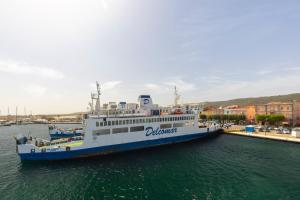 a ferry boat is docked in the water at CA' DU GU' Free wifi - centrale in Carloforte