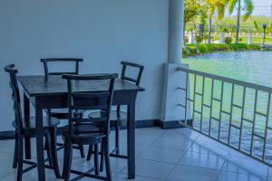 a table and chairs on a balcony with the water at Bundala Park Sanasuma Hotel in Hambantota