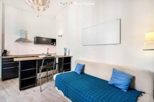 a room with a bed with blue pillows and a desk at Il Palombaro in Riomaggiore