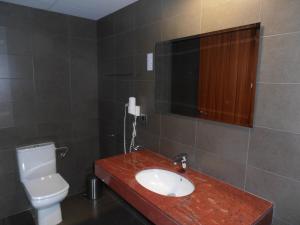 a bathroom with a sink and a toilet and a mirror at Hotel Marblau Tossa in Tossa de Mar